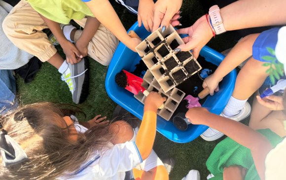 Docente y estudiantes colaborando en una actividad grupal que promueve el respeto, la empatía y el trabajo en equipo.